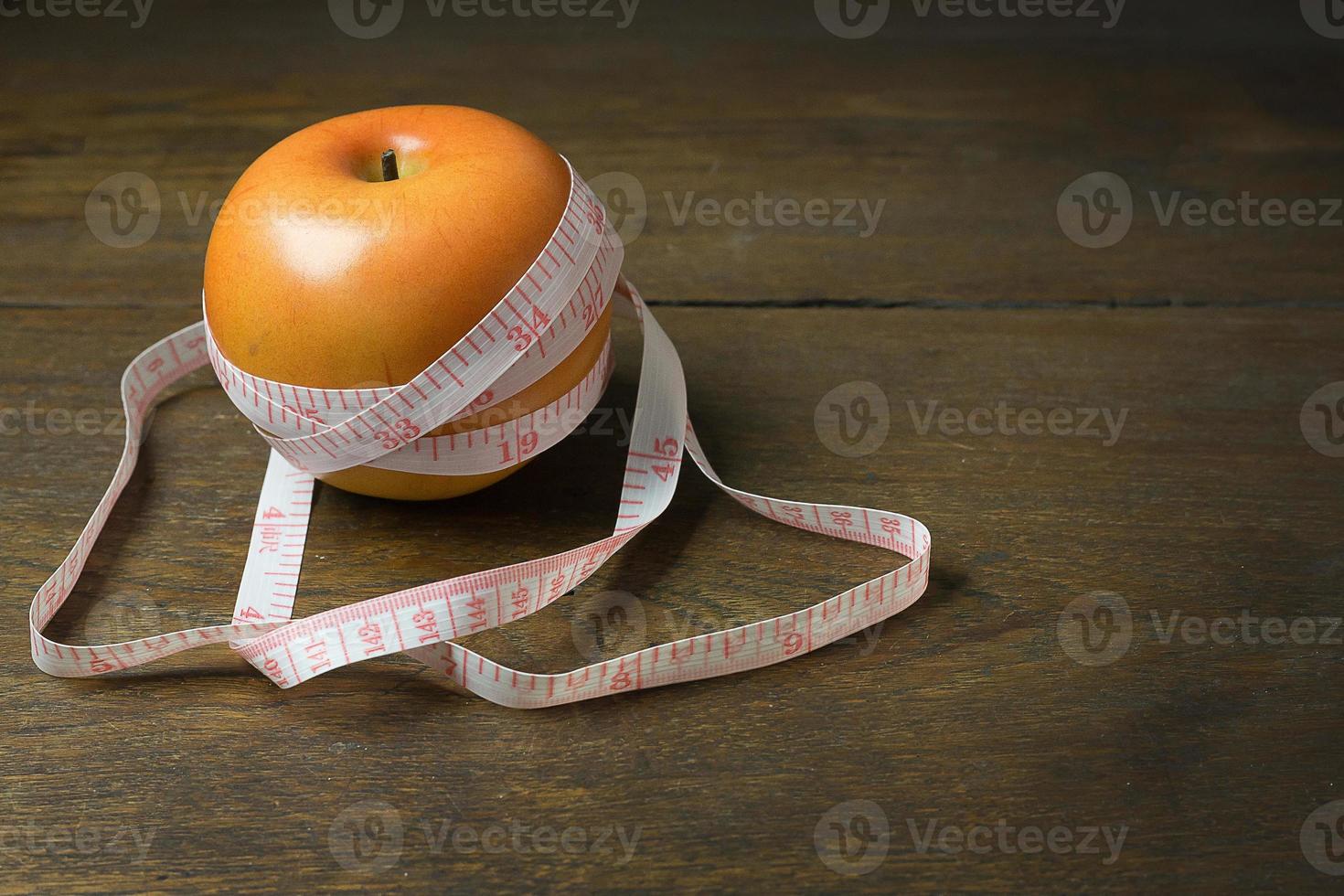 Apple and measuring tape image  for diet content. photo