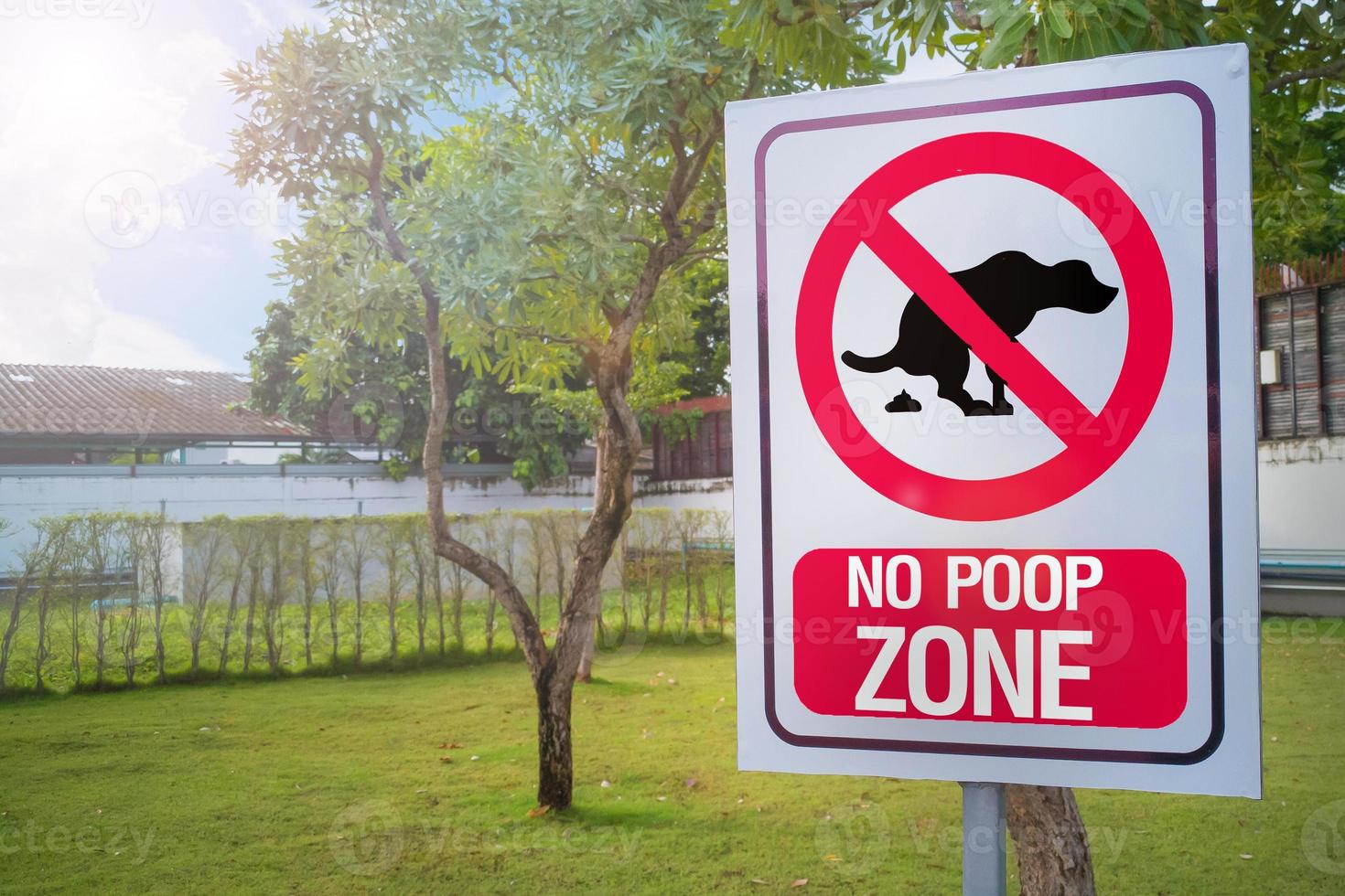 The Sign no poop zone close up image in  garden day light flare. photo