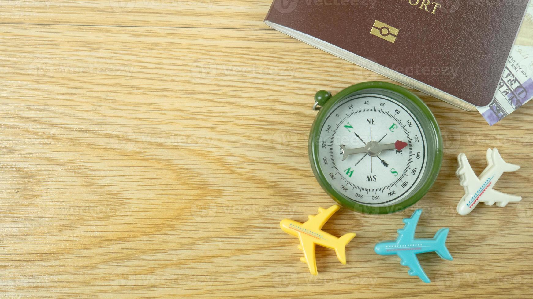 The passport and compass on wood table for travel content. photo