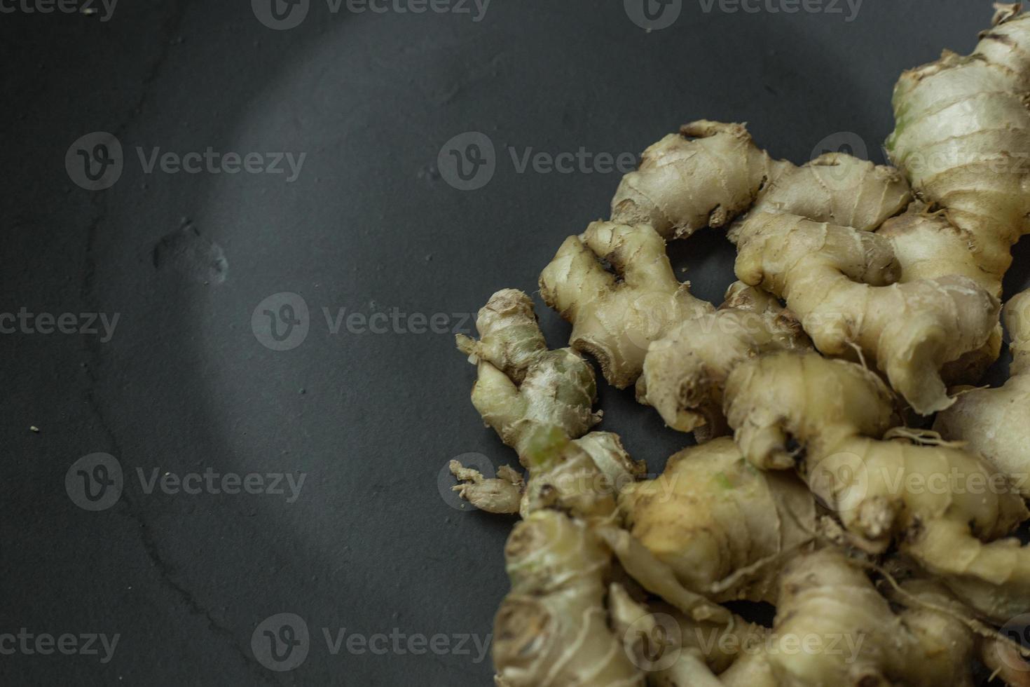 Ginger on black plate for food content. photo