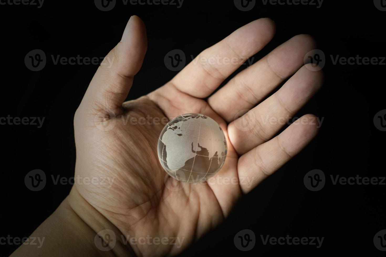 The glass ball planet earth and hand image. photo