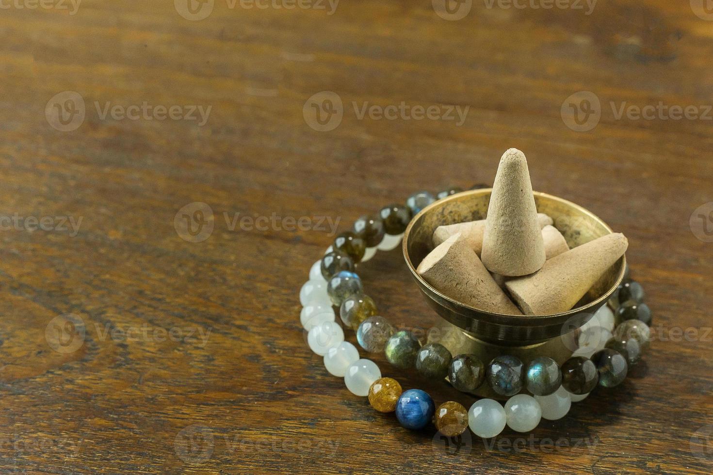 Incense Cone in a stand with the feather for background. photo