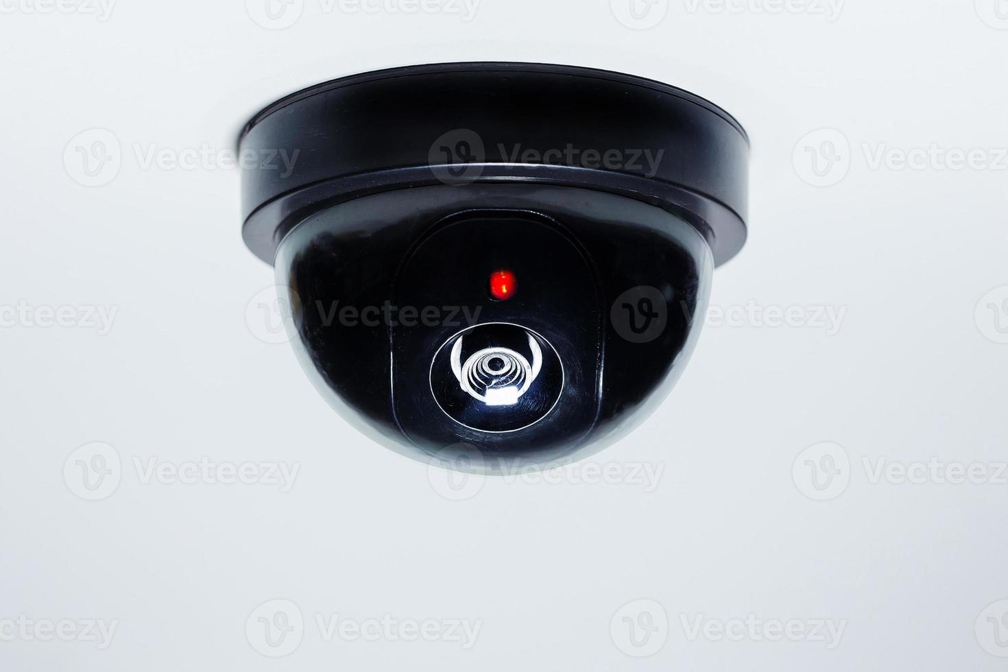 A security camera or cctv camera on ceiling . photo