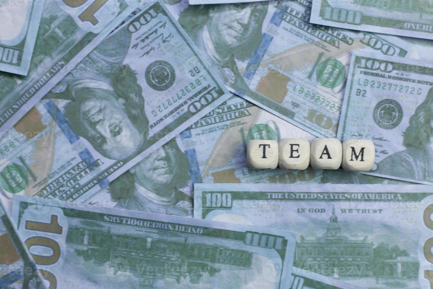 Team word on wood brick  background banknote. photo