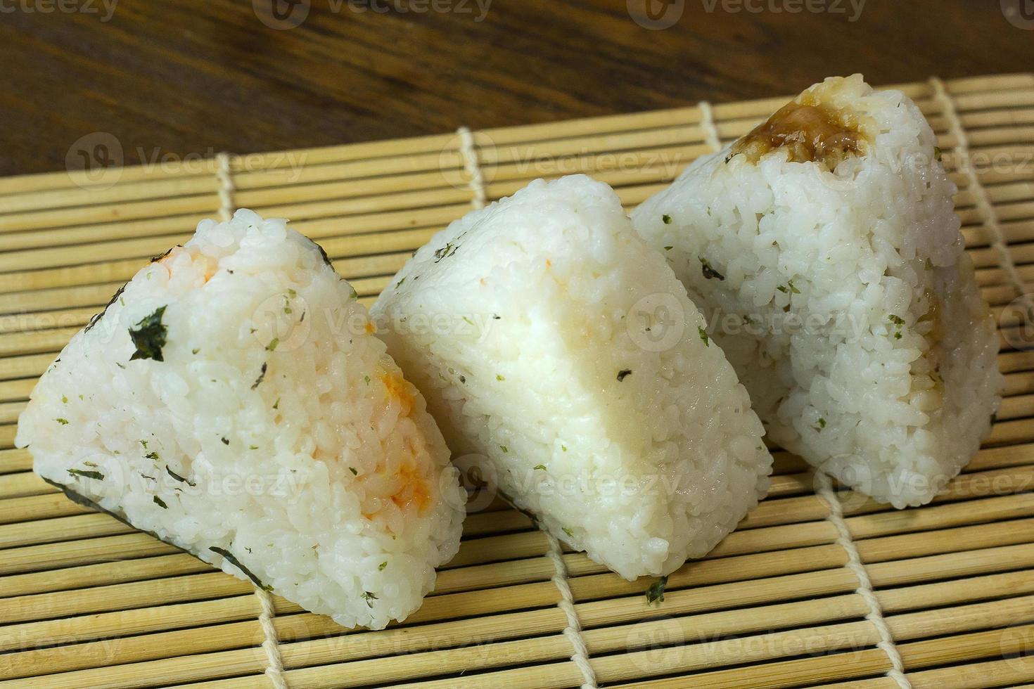 The Japanese food Onigiri  white rice formed into triangular or cylindrical shapes and often wrapped in nori. photo