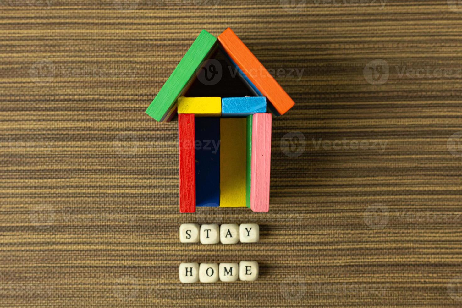 stay home on wood cube and home toy for social distancing content. photo