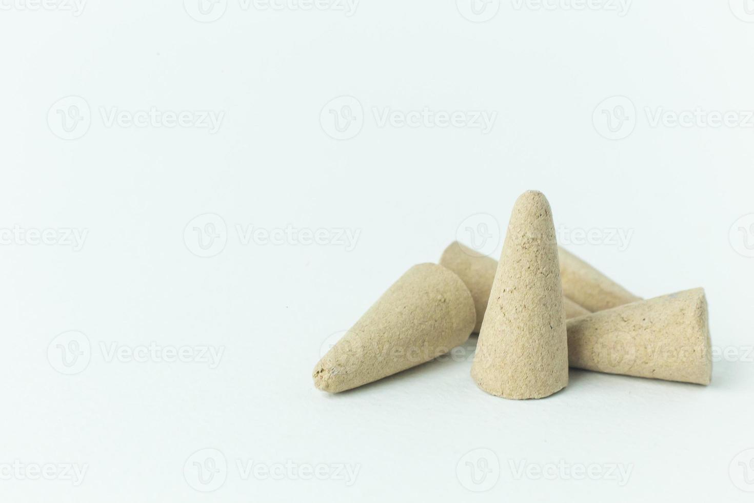 Incense Cone in a stand with the feather for background. photo