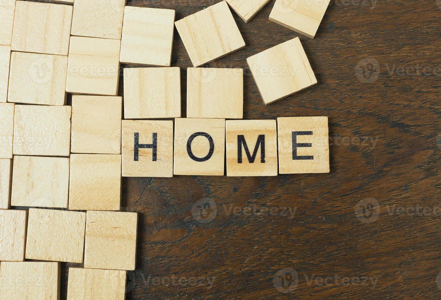 Home word on wood plate abstract background. photo