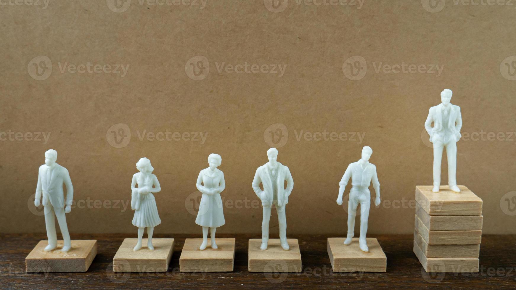 small figure model on wood table for business content. photo