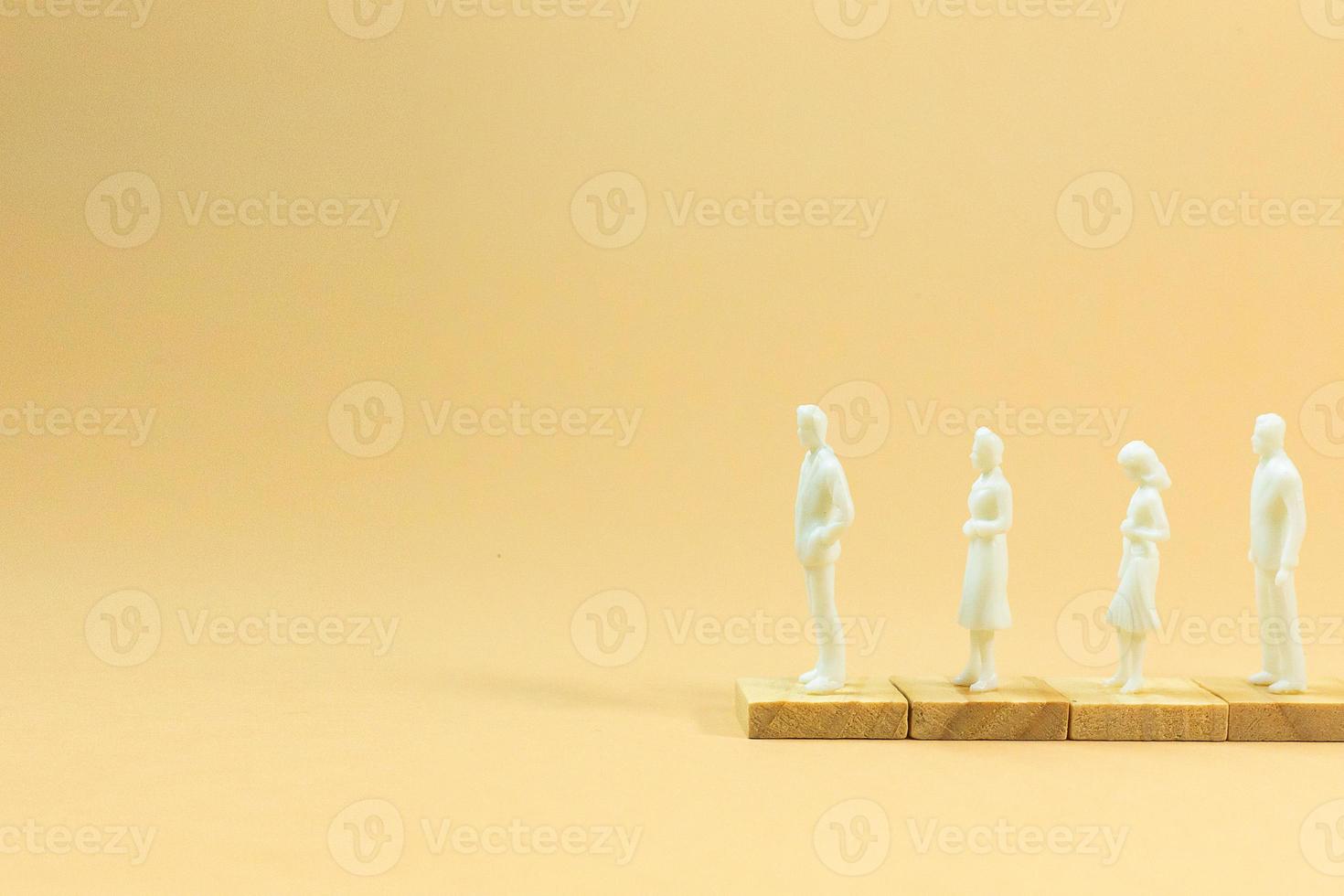 white  figure miniature on orange pastel for business content. photo