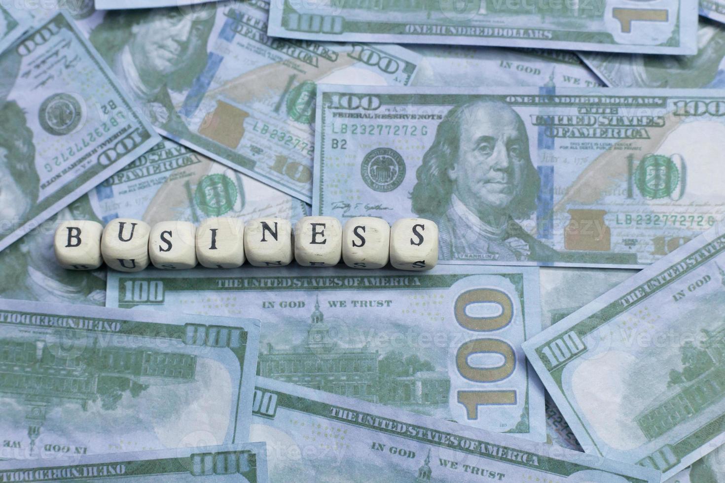 Business word on wood brick  background banknote. photo