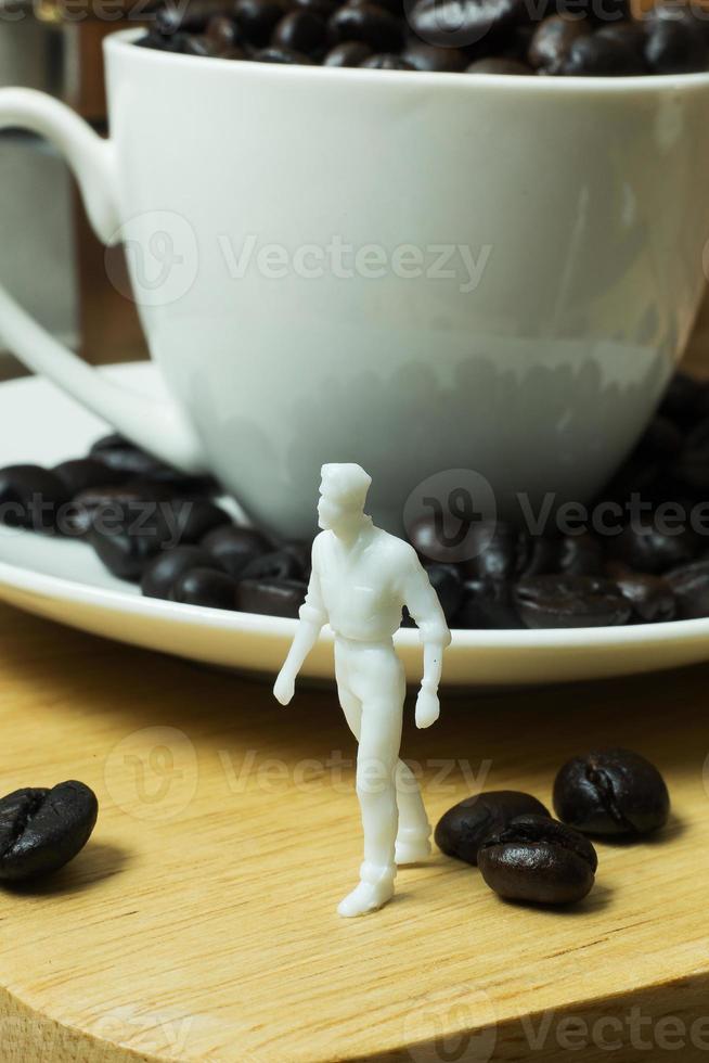 The white miniature and coffee beans vintage mood and tone photo