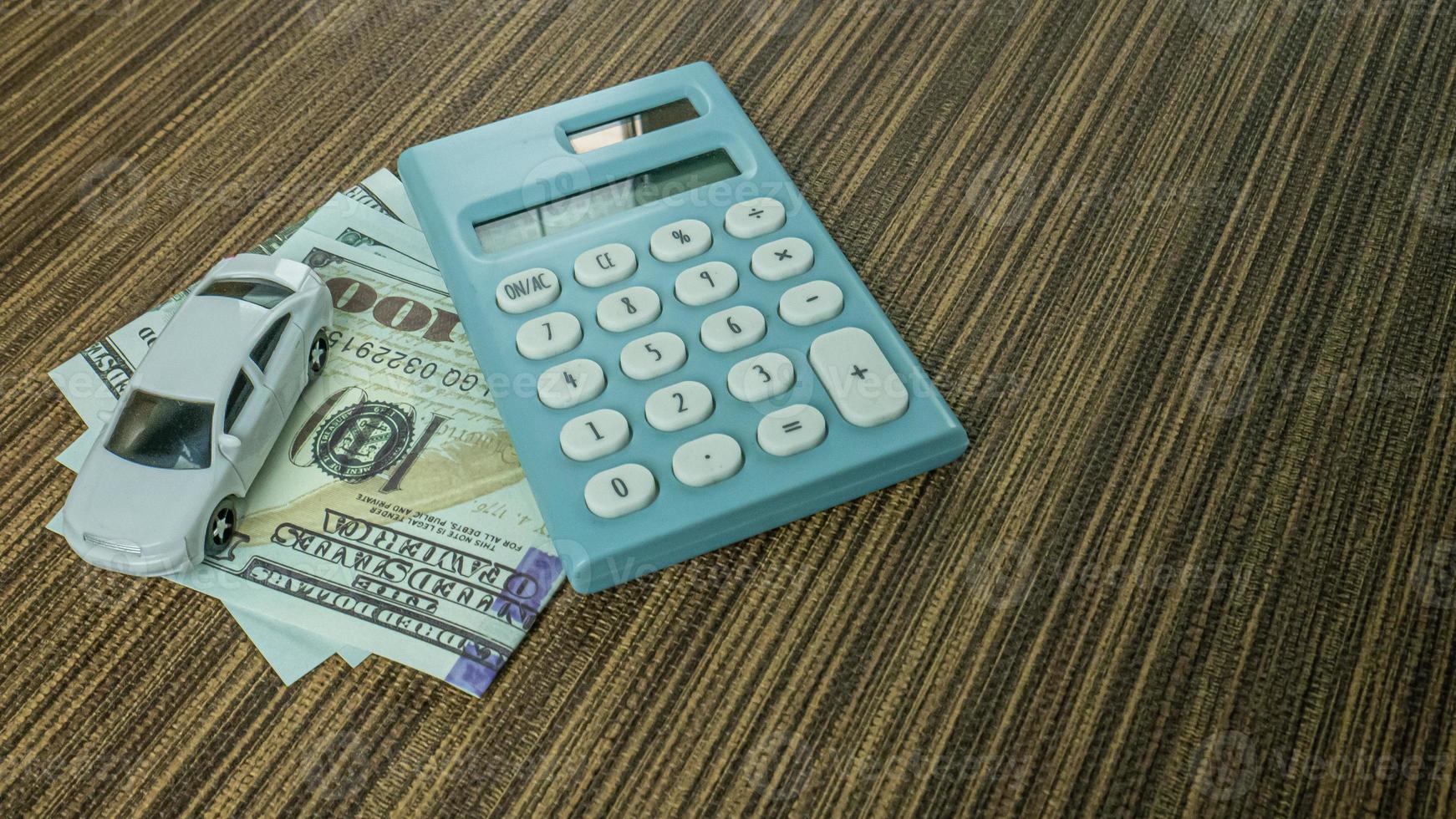 car and calculator on wood table for business content. photo