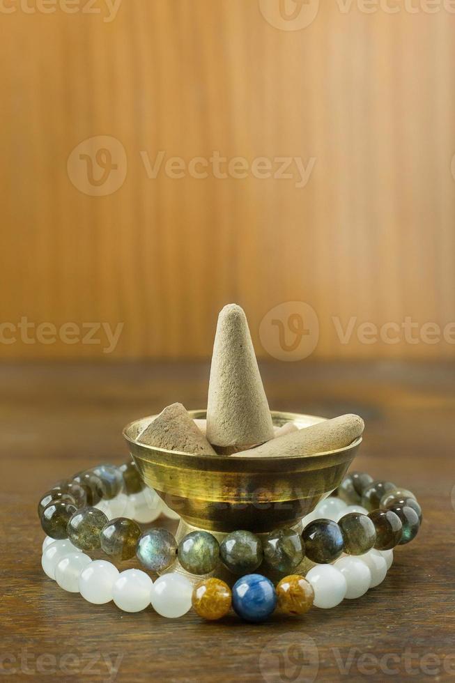 Incense Cone in a stand with the feather for background. photo