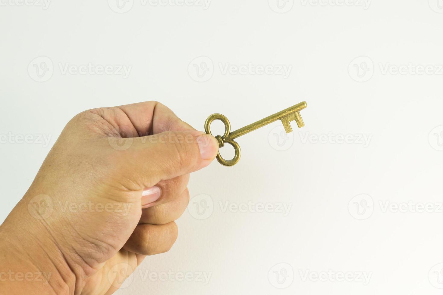 vintage gold key in hand close up image. photo