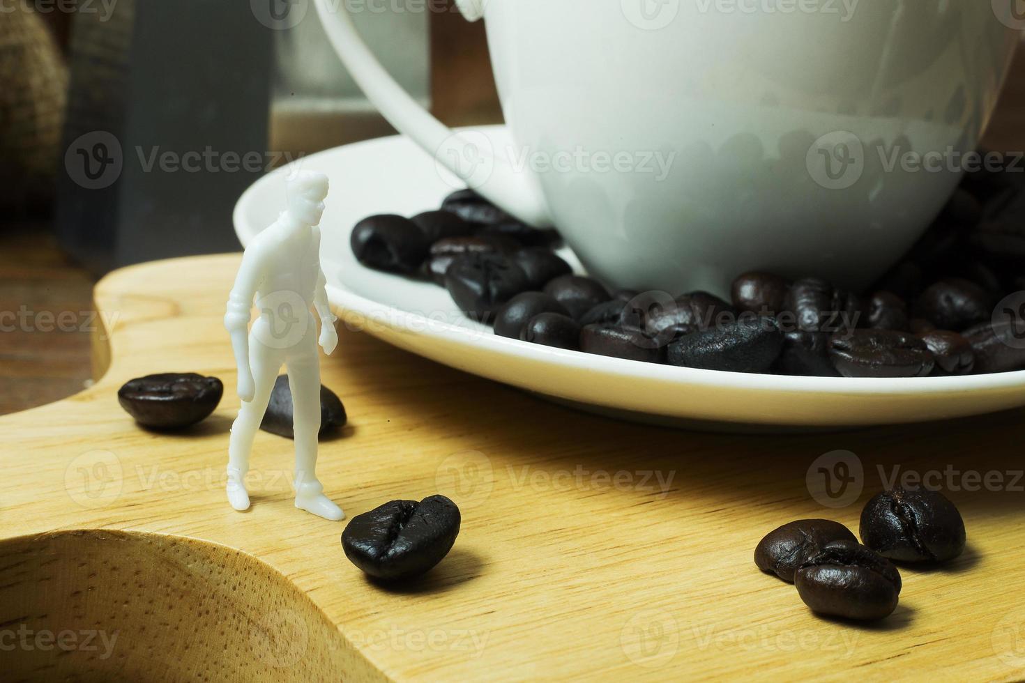The white miniature and coffee beans vintage mood and tone photo