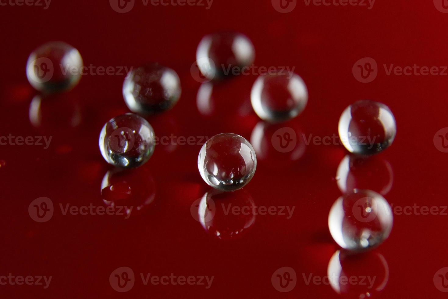 The abstract  crystal ball on red glossy floor background. photo