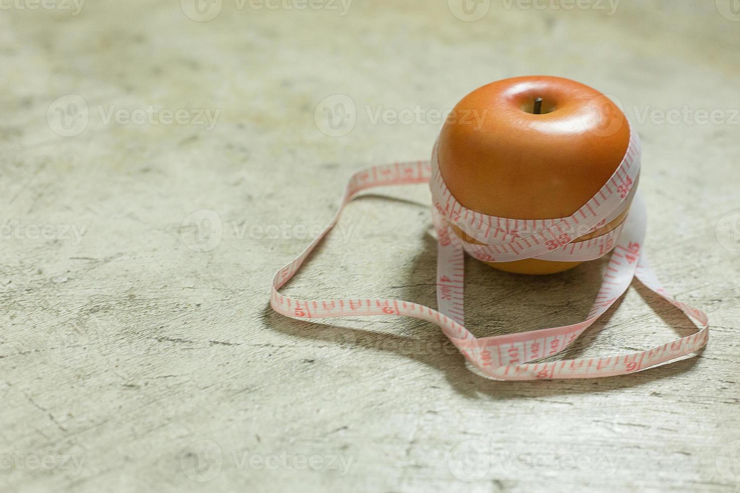 Apple and measuring tape image  for diet content. photo