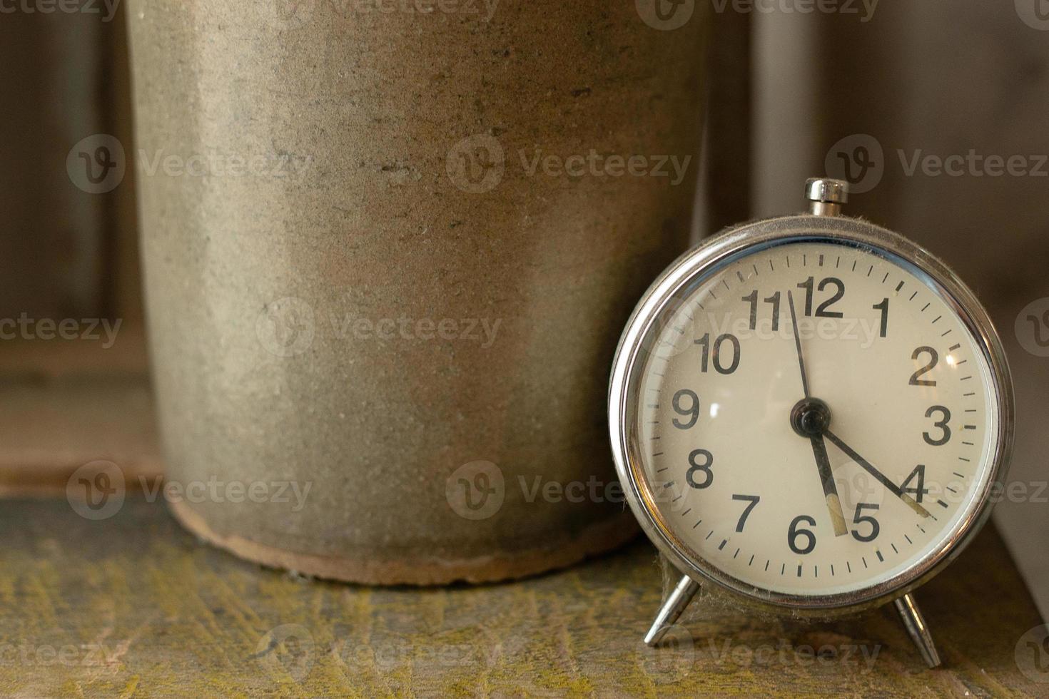 White vintage clock alarm  near window light. photo