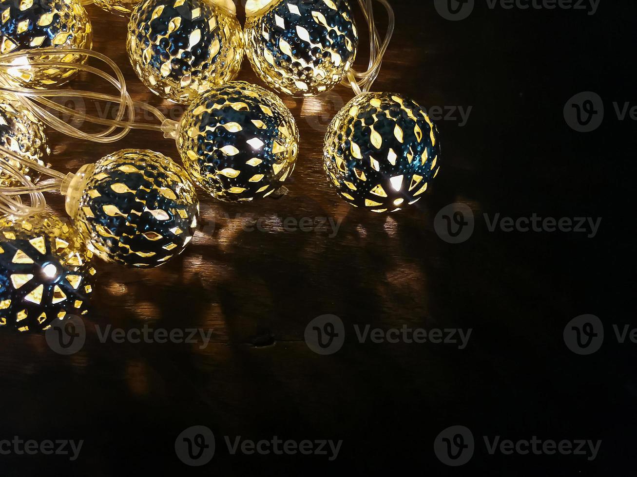 Christmas lights ball decor on wood table. photo