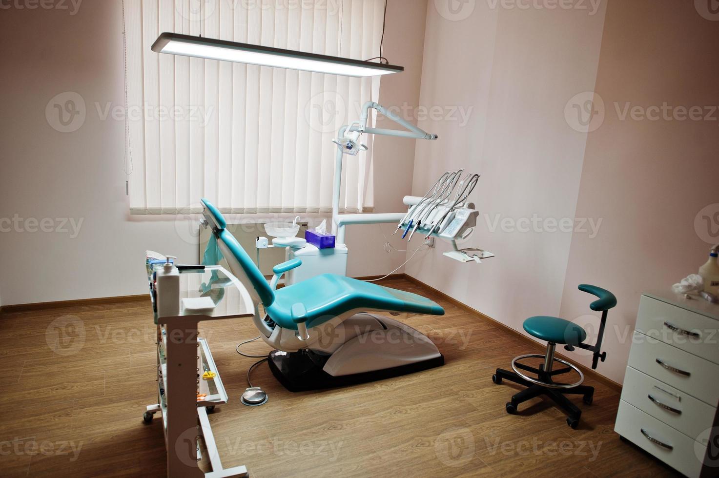 Dental chair by dentists in blue with medic light. Modern dental practice. photo