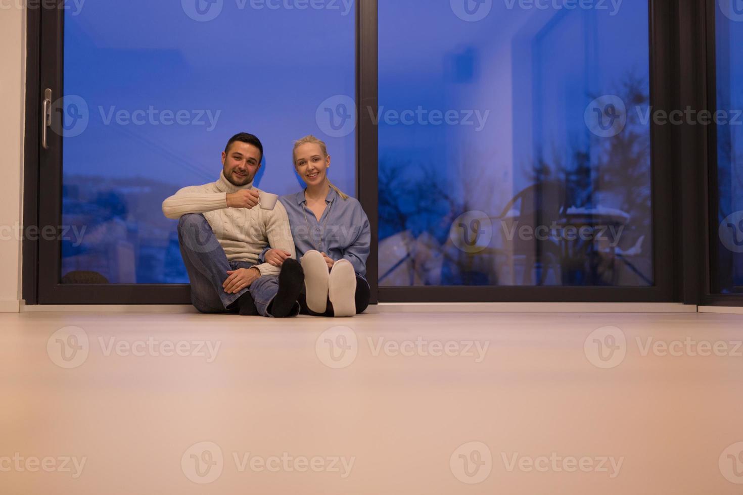 happy couple in front of fireplace photo