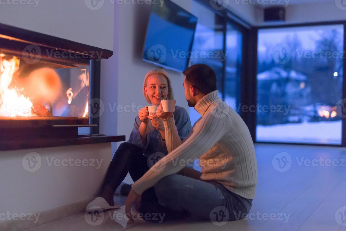 happy couple in front of fireplace photo