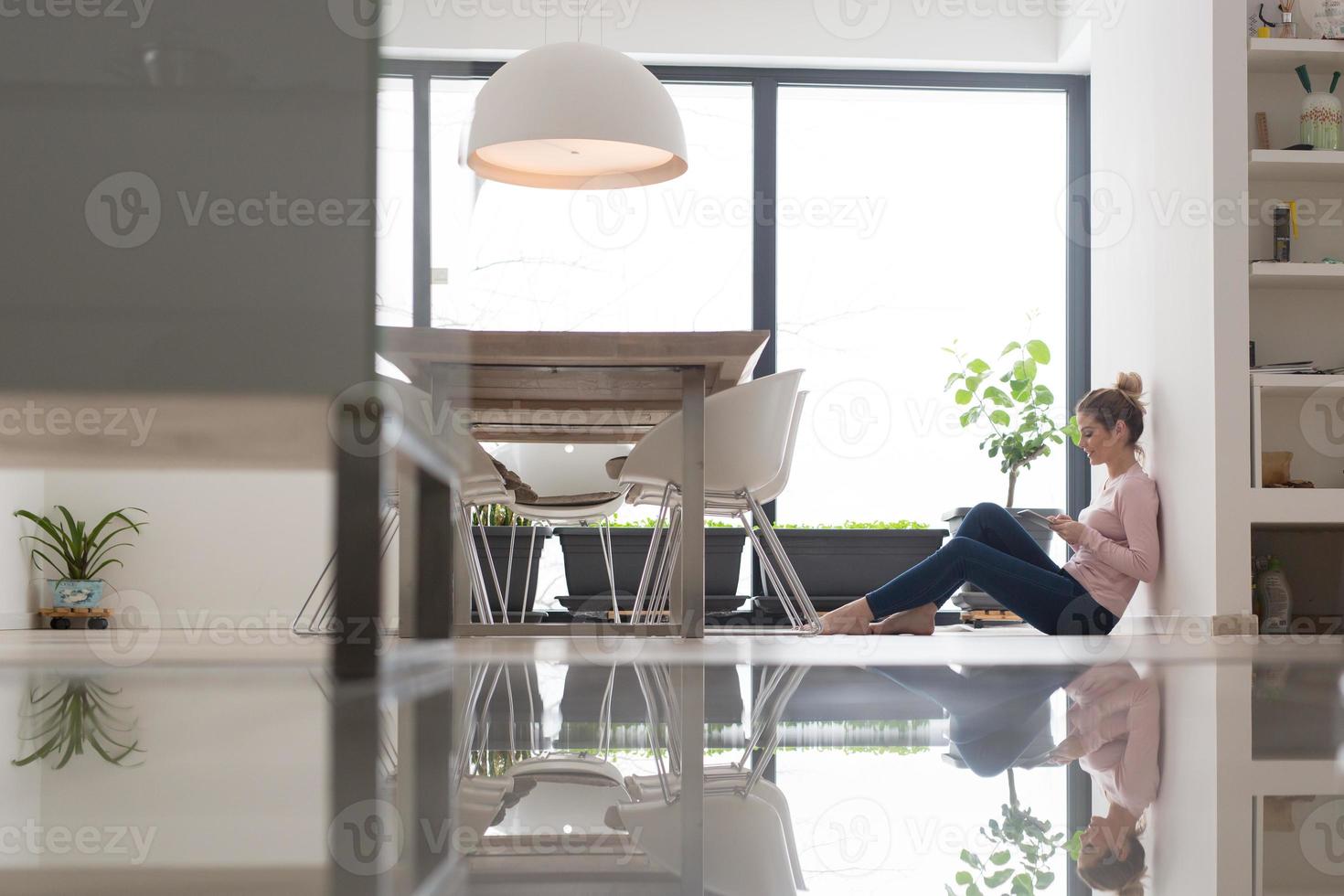 young woman using tablet computer on the floor photo