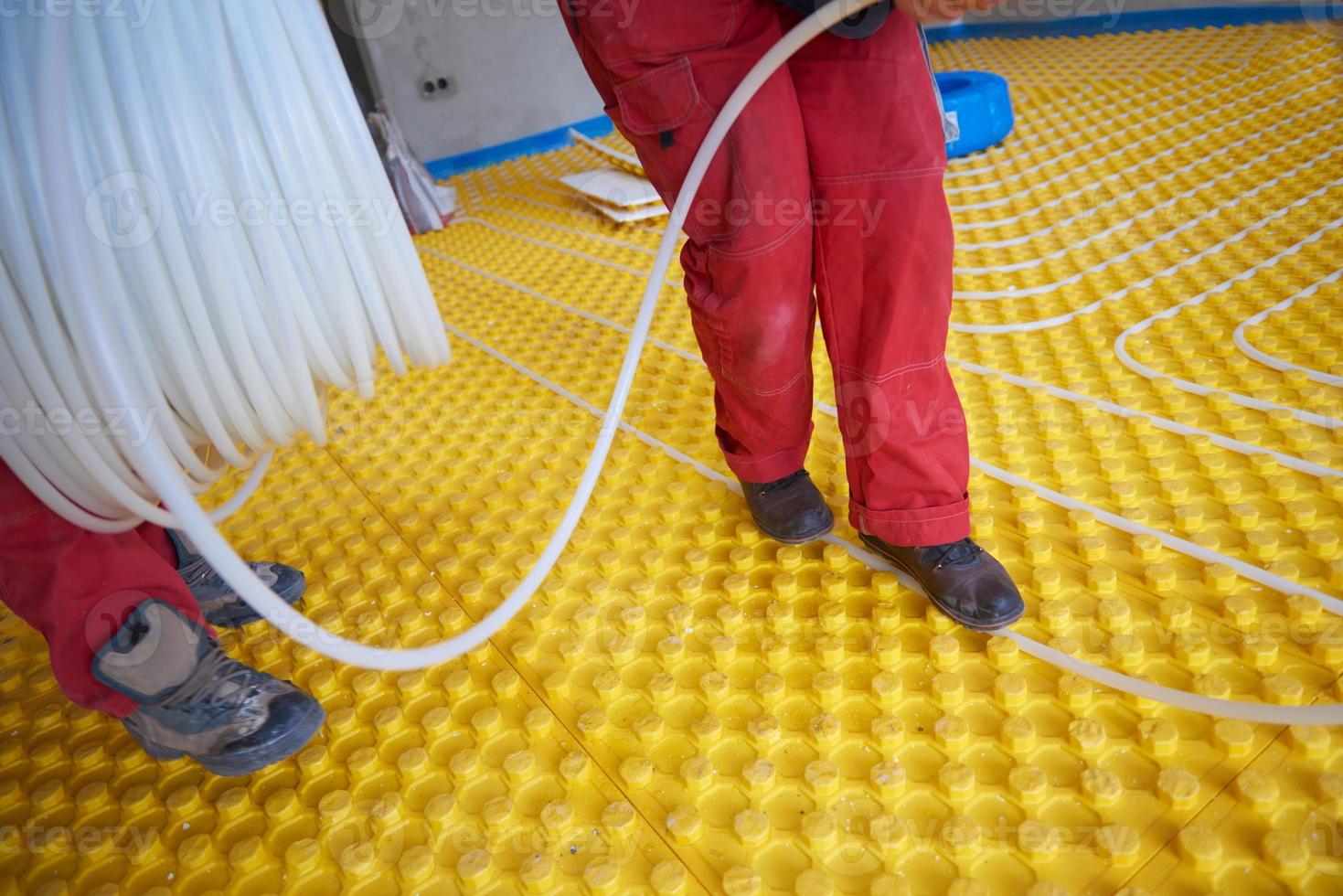workers installing underfloor heating system 10357917 Stock Photo at