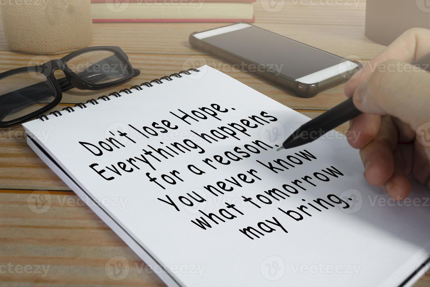 Motivational and inspirational quote written on notepad . photo