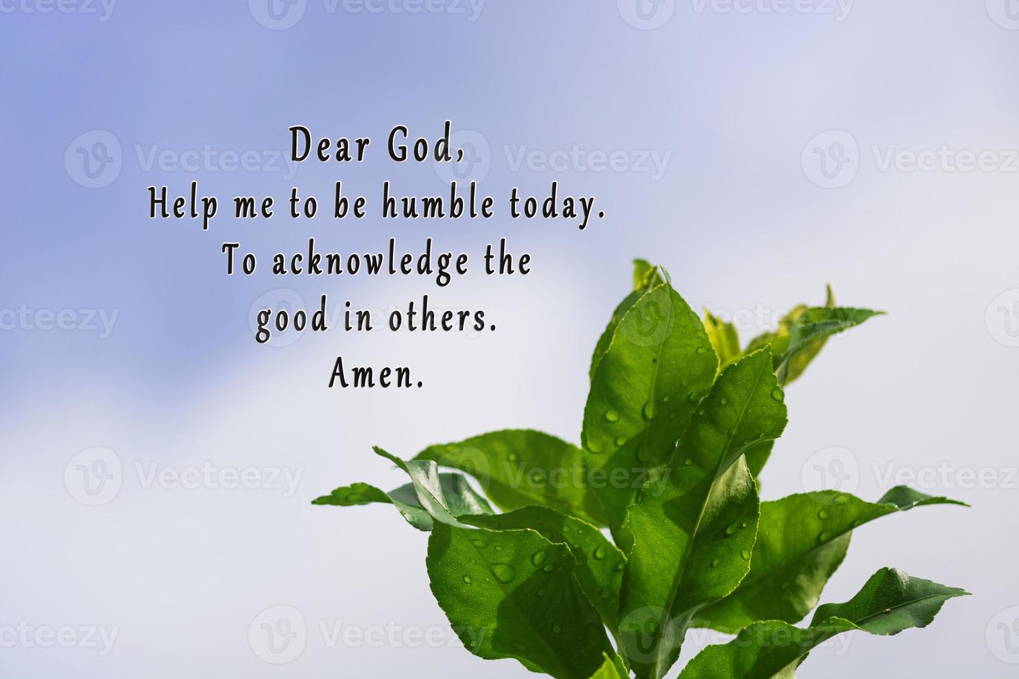 Prayer text with green leaves against clear blue sky background. photo
