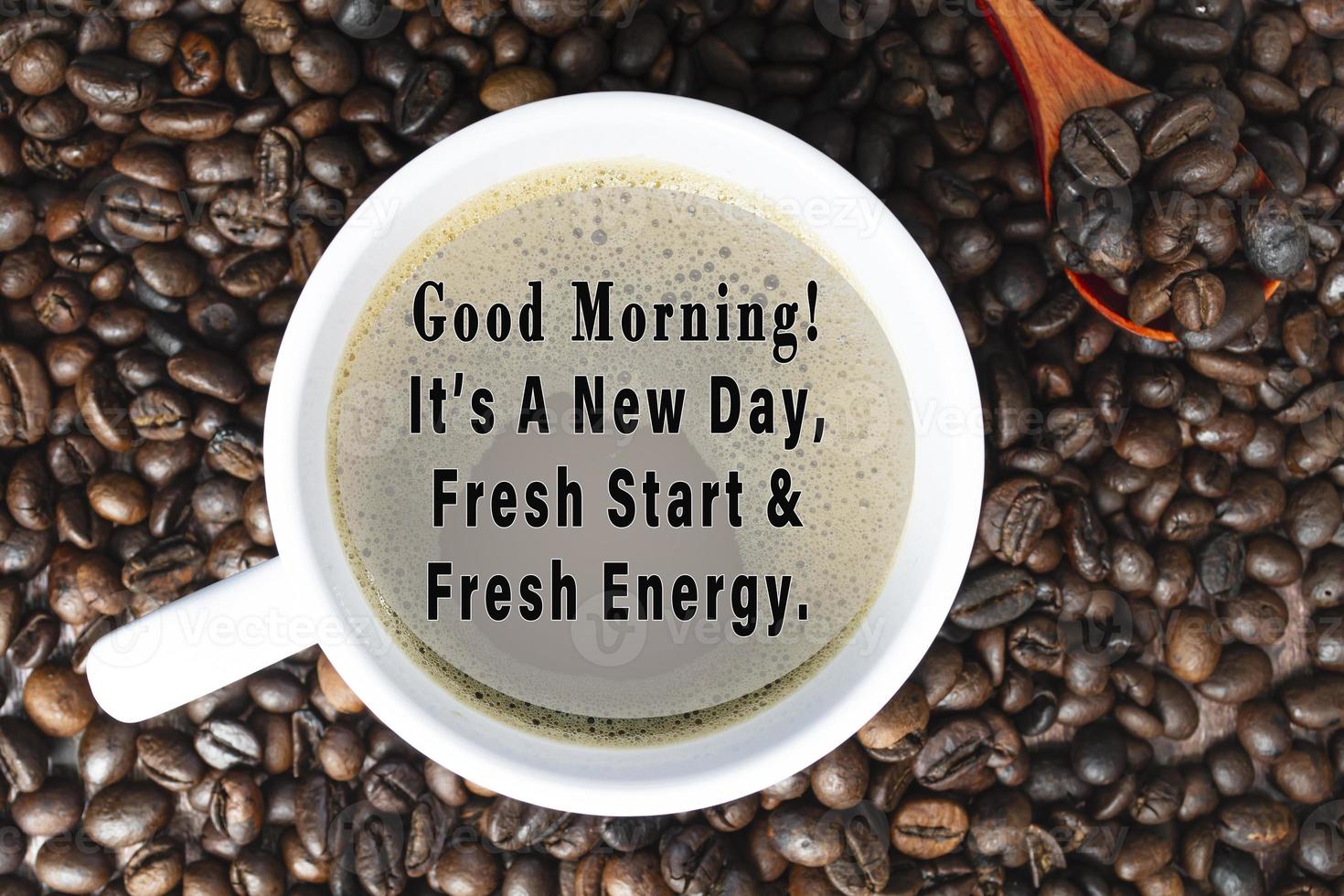 Motivational quote on cup of coffee on coffee beans background. photo