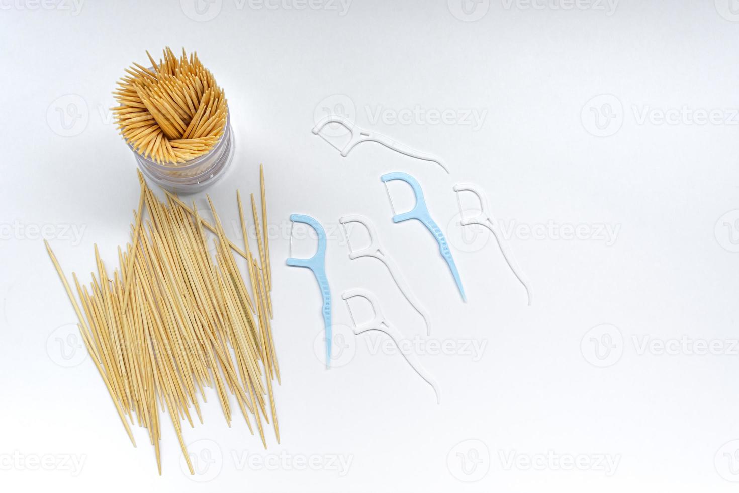 Pile of round wooden toothpicks on white background. Copy space. photo