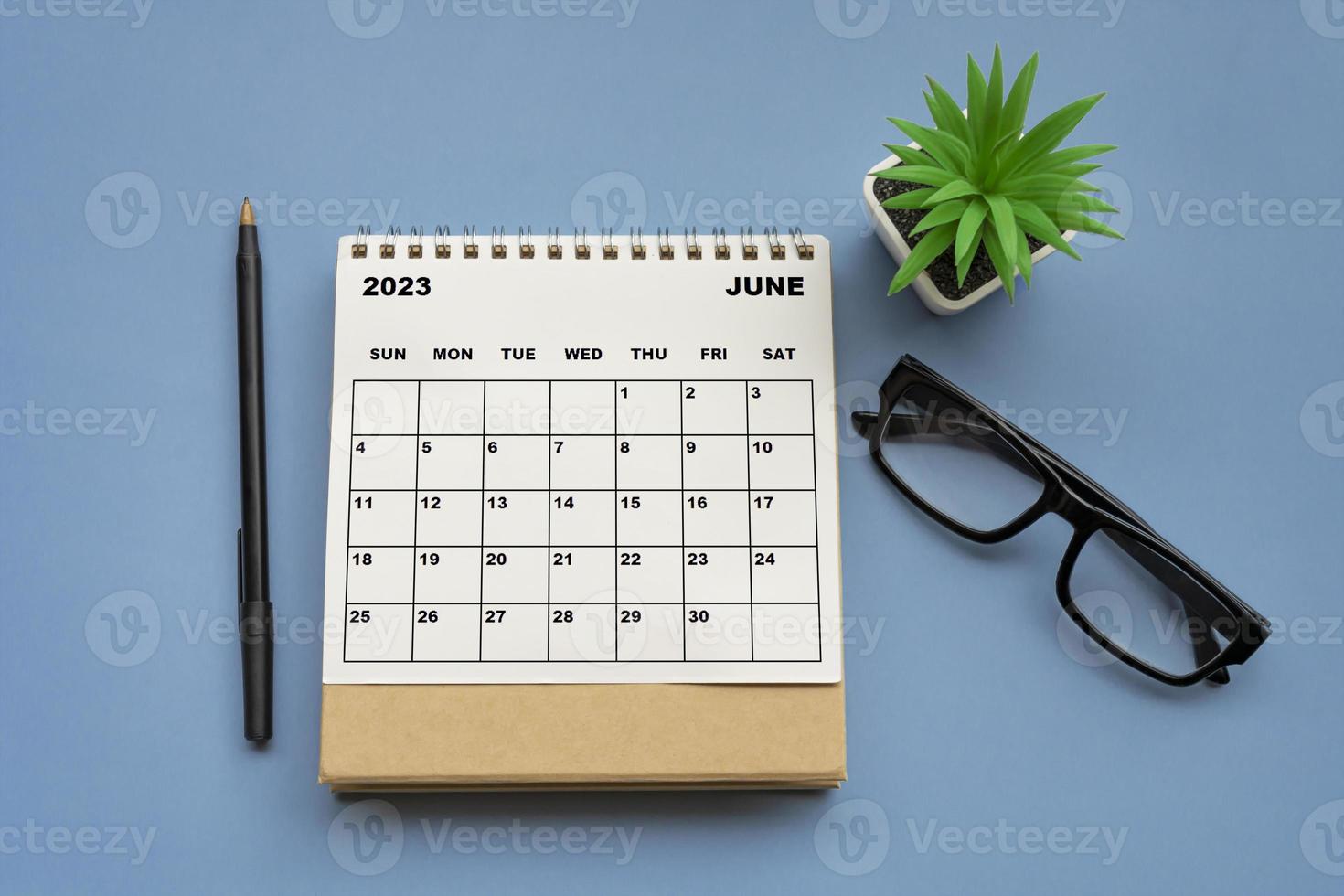 June 2023 desk calendar on blue background. Directly above. photo