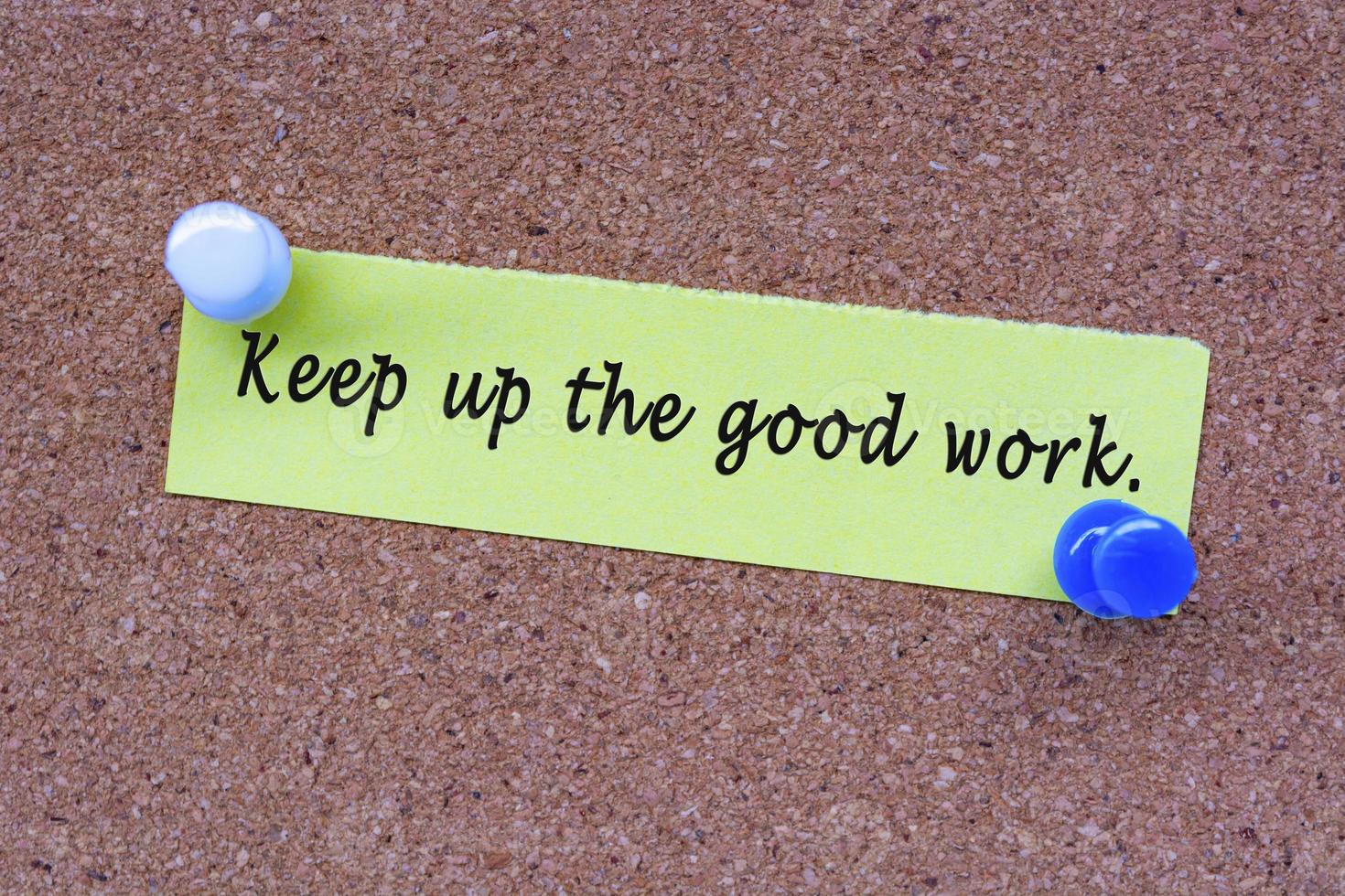 Keep up he good work words on stick note and pinned to a cork notice board. photo