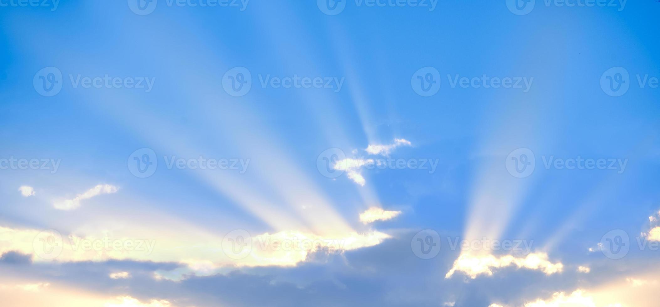 Horizontal shot of background of sun rays over clouds. photo