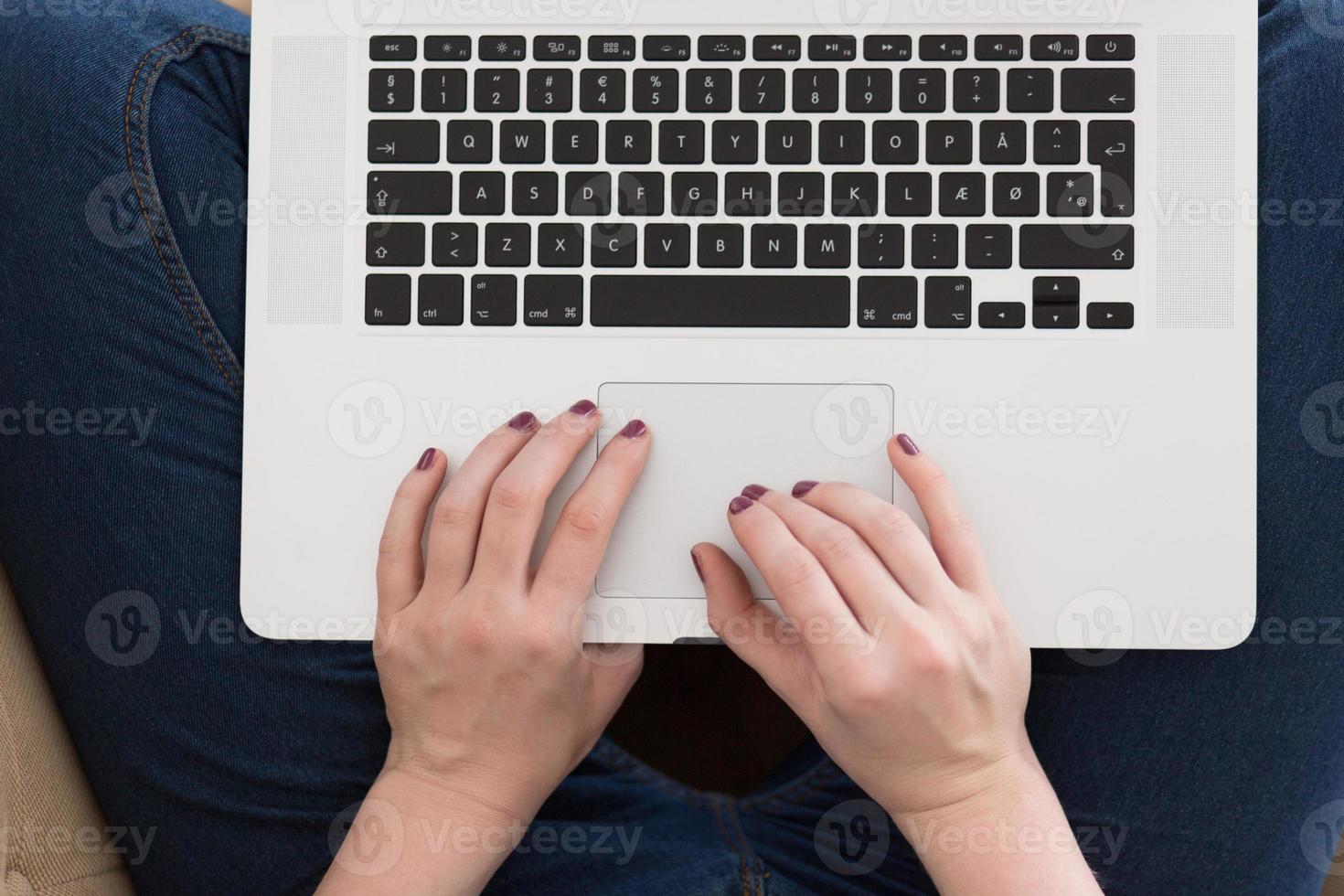 young woman on sofa at home websurfing photo