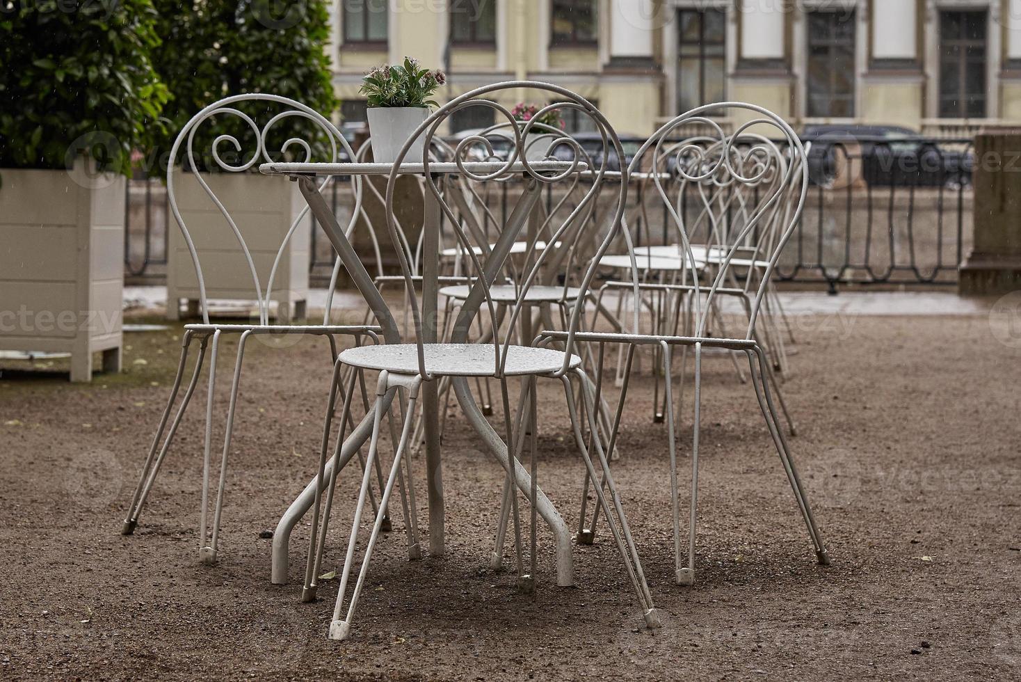 Empty cafe and white metal tables in the Park. Ban on visiting public places due to threat of coronavirus. photo