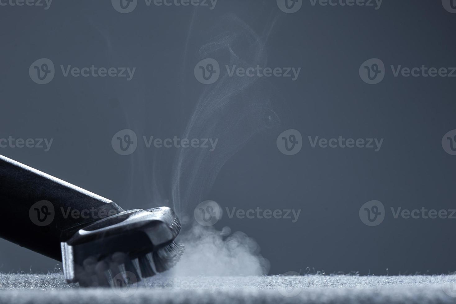 Steam carpet cleaning on a grey background. Photo from copy space.