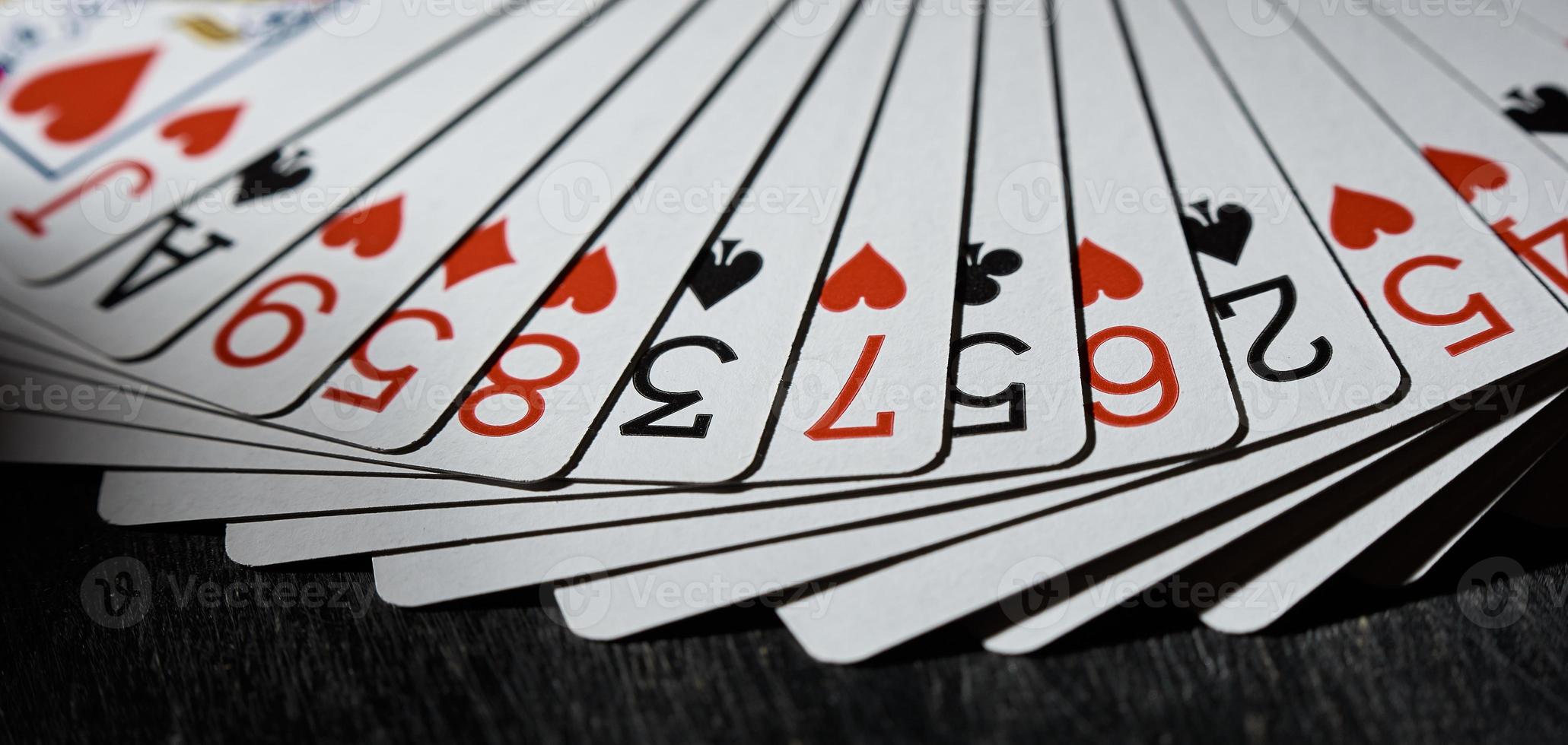 Playing cards fanned out on a black background. The concept of the game. photo