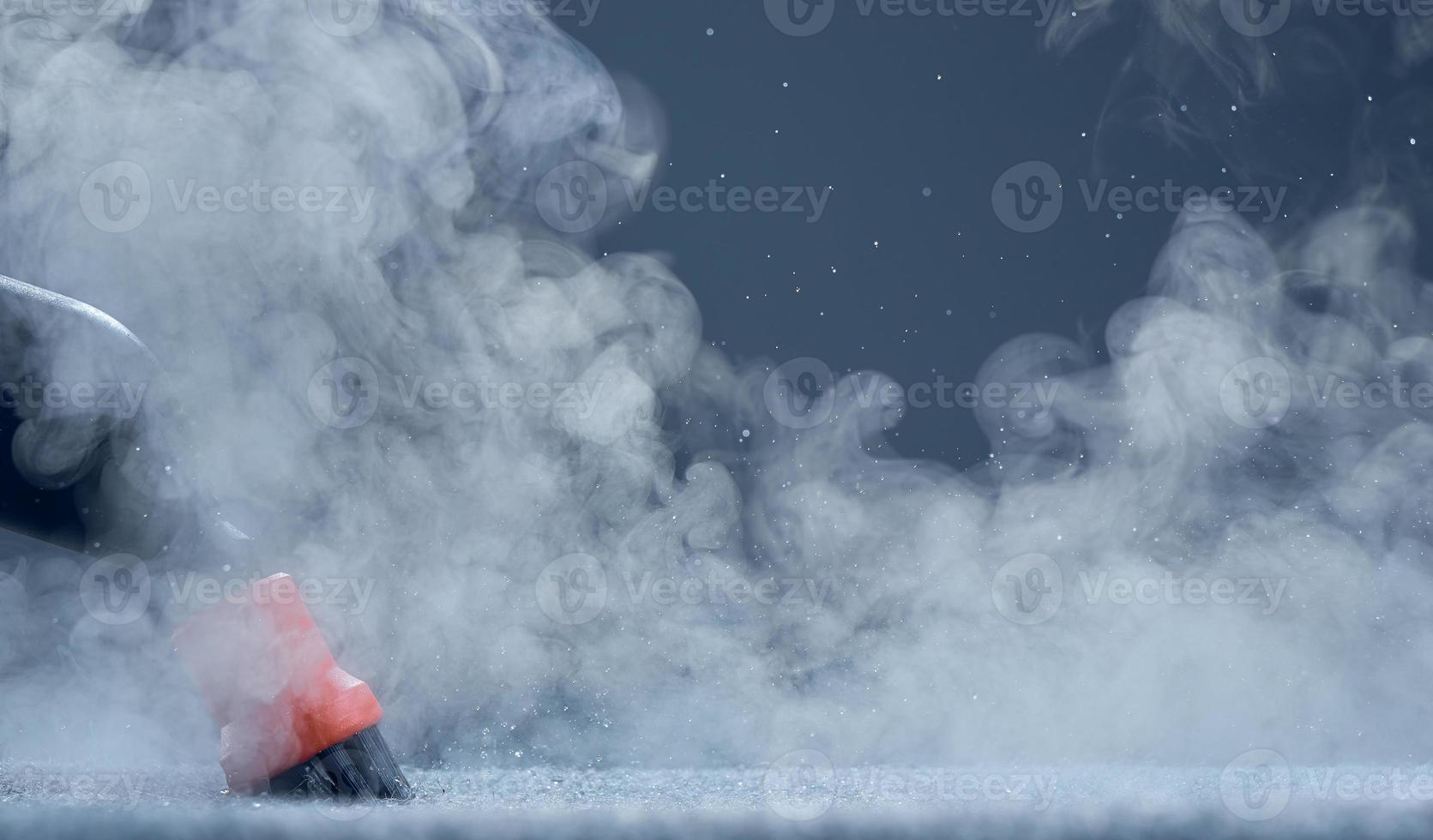 Steam close-up. Steam carpet cleaning on blue background. Home cleaning. Photo with copy space.