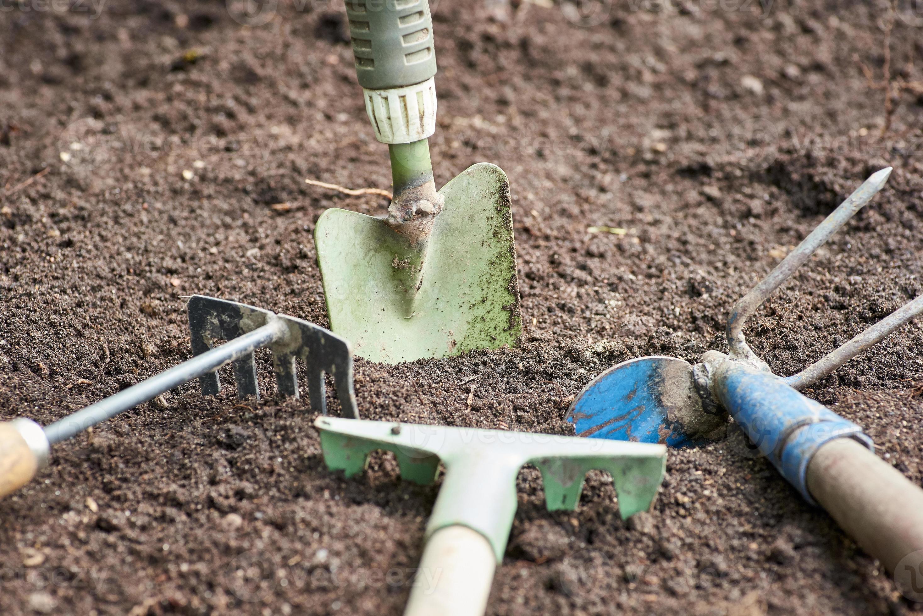 Garden tools in the garden. Background of dirty garden supplies