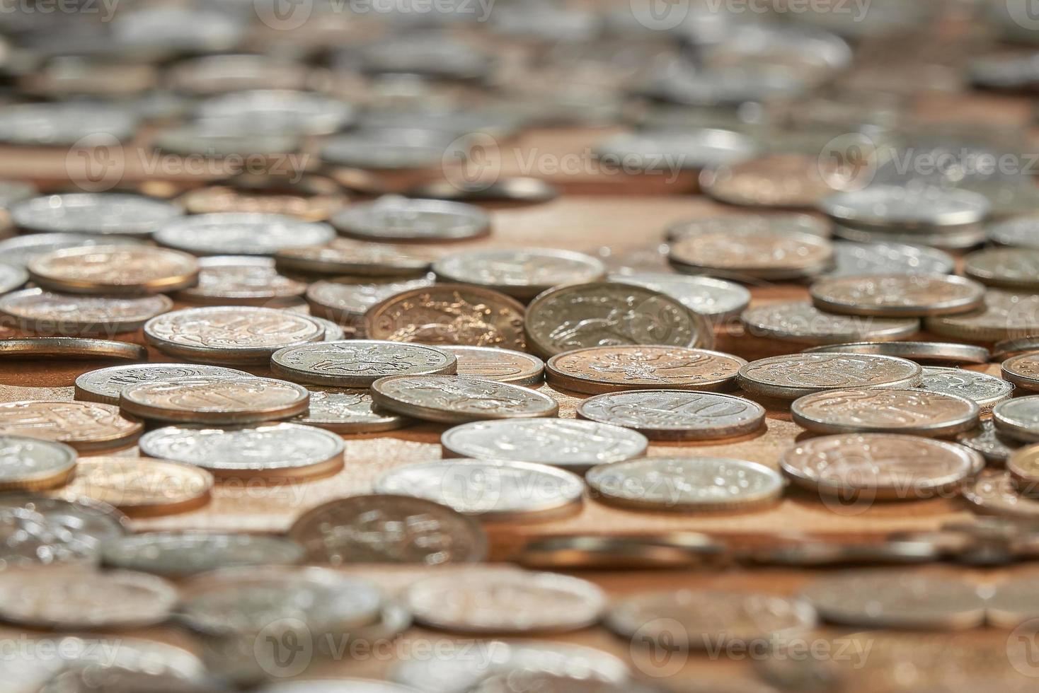 Close up side view image of large amount of coins. photo