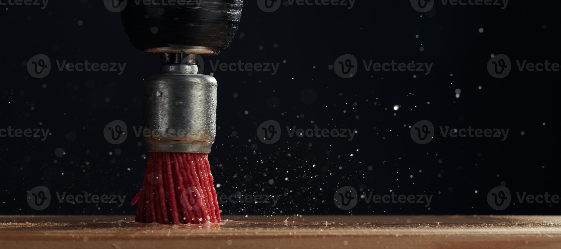 Soft brush on the drill close-up on dark background . Cleaning the surface with an electric tool. Photo with copy space. Side view.