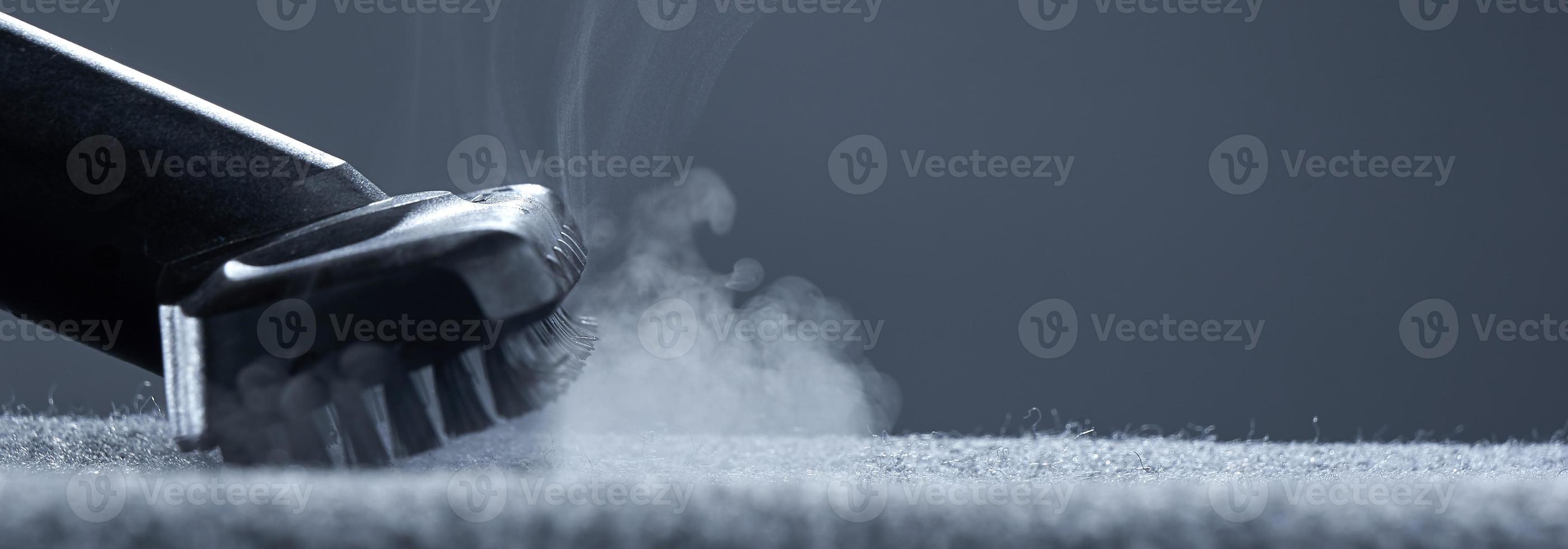 Home cleaning. Steam carpet cleaning on a grey background. Photo from copy space.