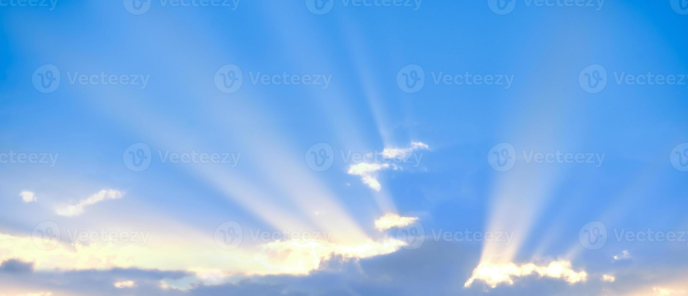 Horizontal shot of background of sun rays over clouds. photo