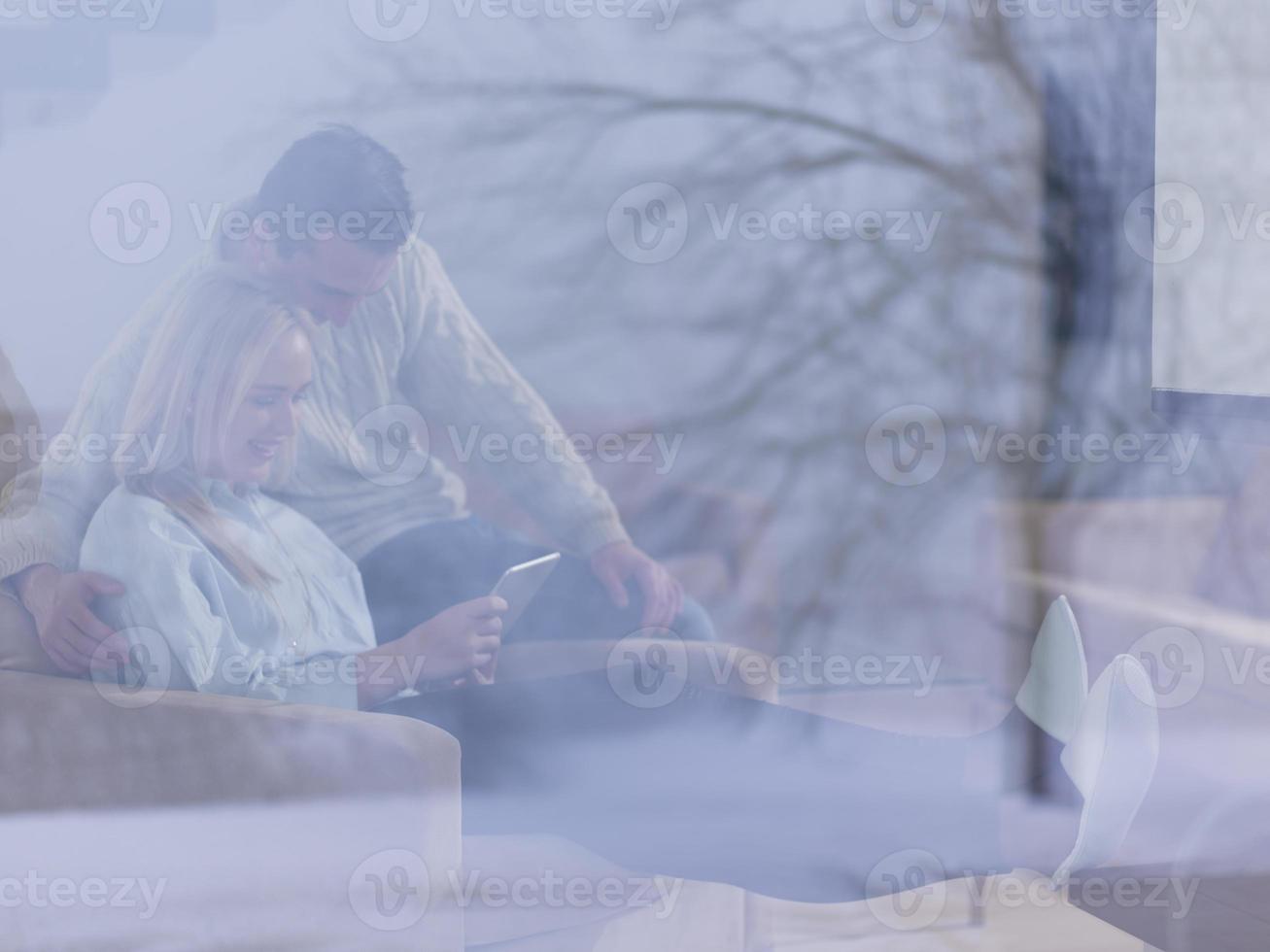 Couple using digital tablet on cold winter day photo