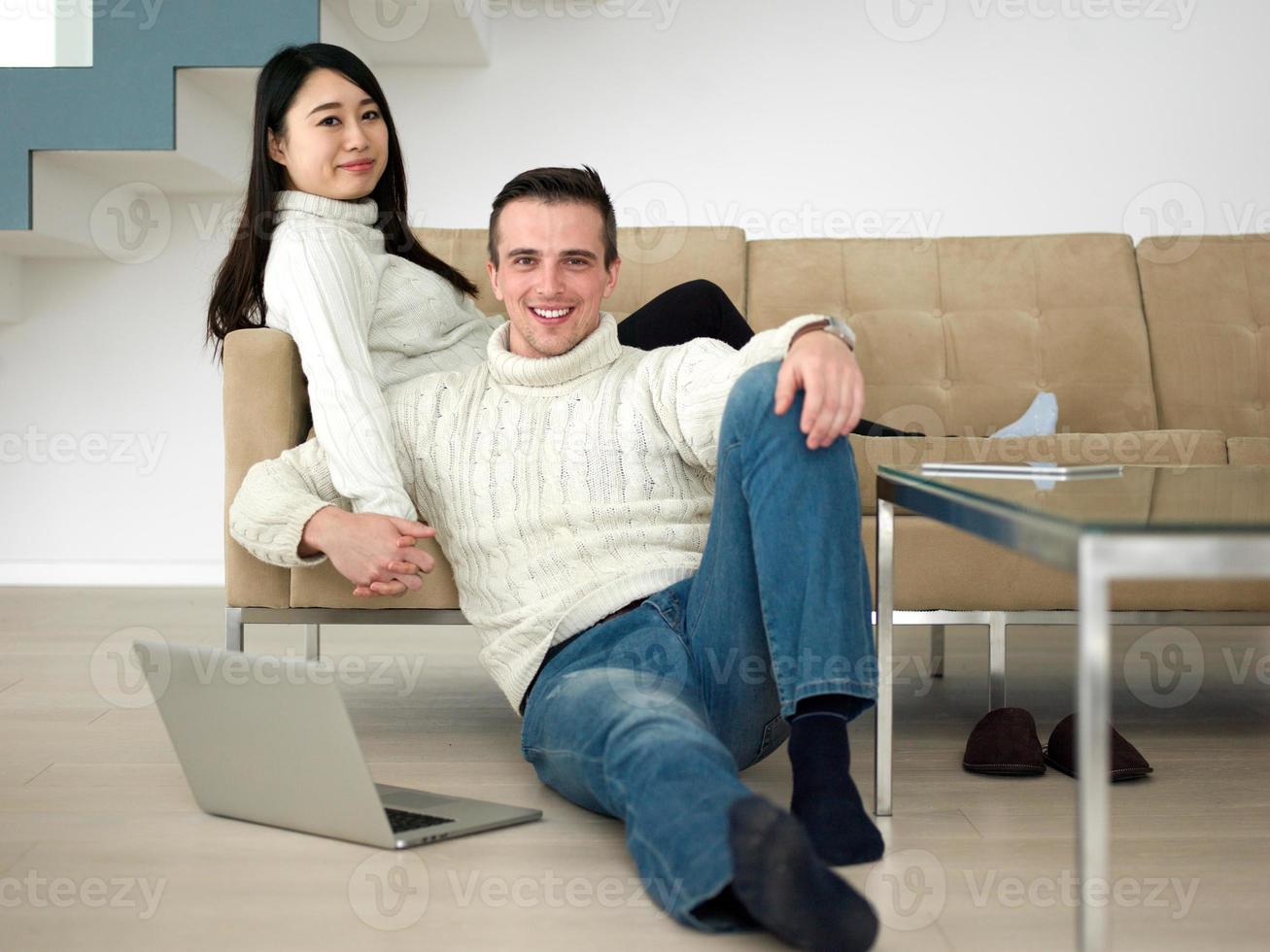 happy multiethnic couple relaxing at home photo