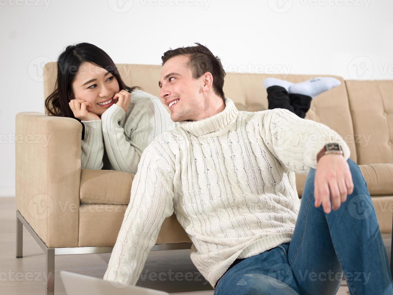 happy multiethnic couple relaxing at home photo
