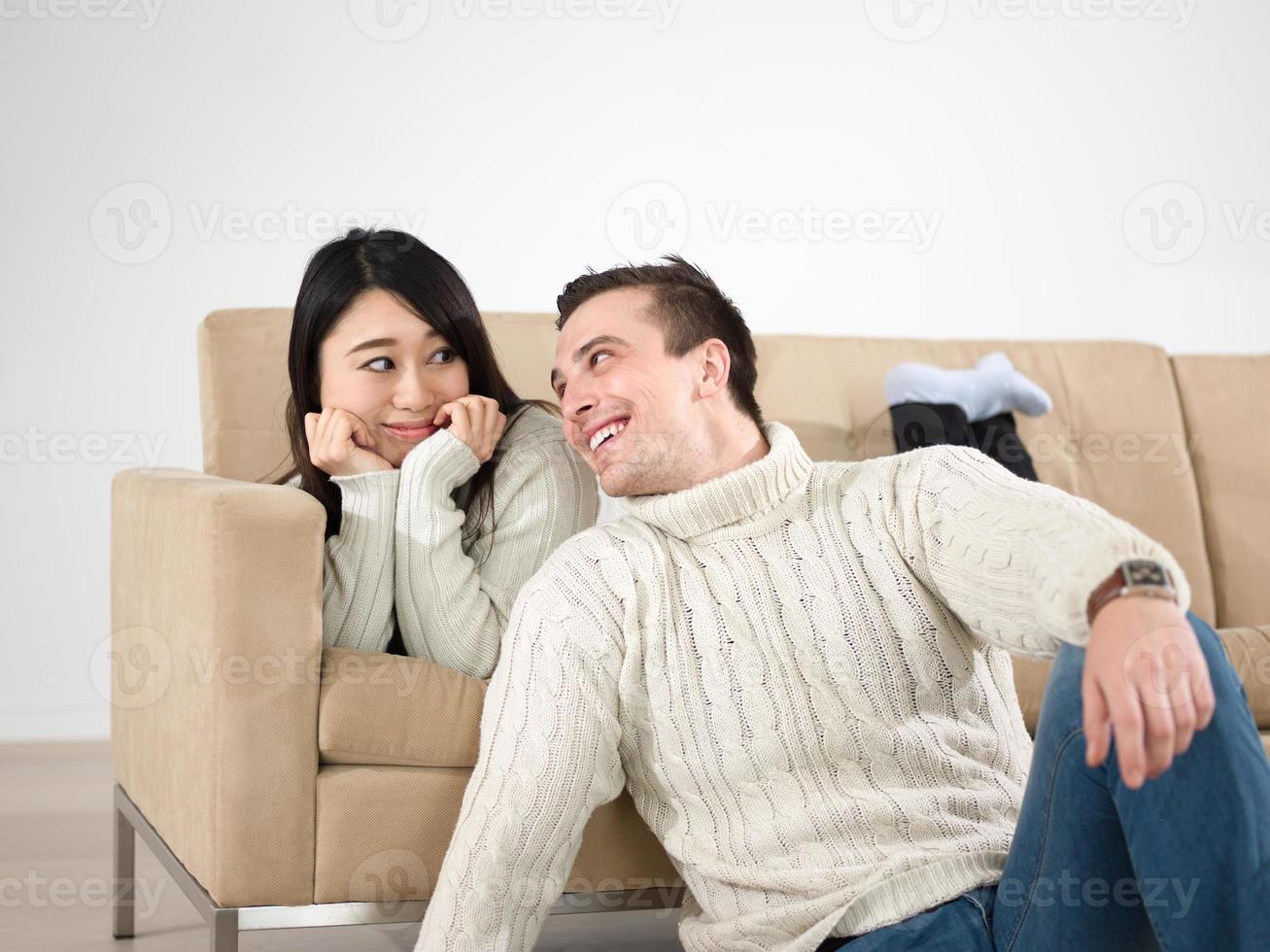 happy multiethnic couple relaxing at home photo